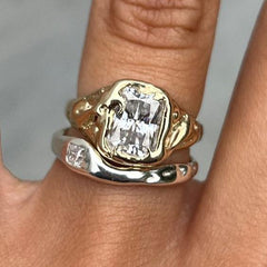 Two-tone stacking ring set with a wide emerald-cut clear stone