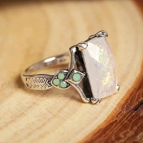 Vintage-style silver-tone ring with a large kite-shaped white opal stone and pale green accents on the shoulders
