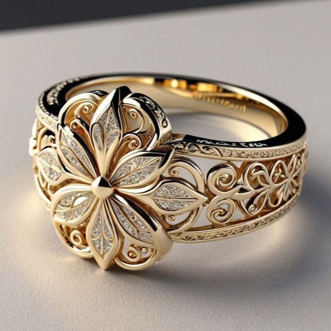 Wide gold-tone band ring with a raised flower and openwork filigree sides