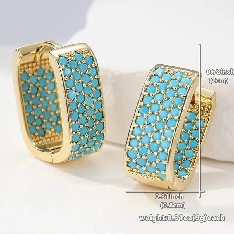 Wide gold-tone huggie hoop earrings pave set with turquoise-effect stones