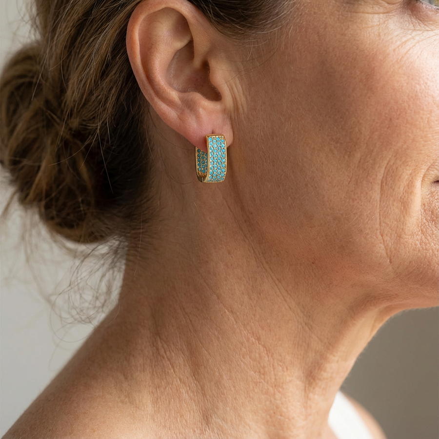 Wide gold-tone huggie hoop earrings pave set with turquoise-effect stones