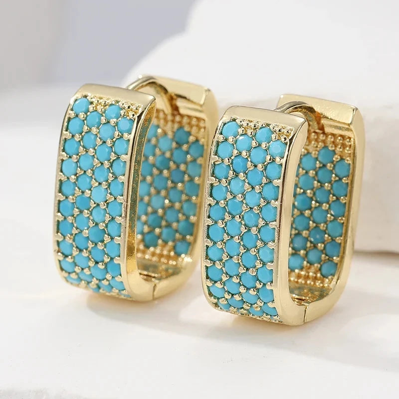 Wide gold-tone huggie hoop earrings pave set with turquoise-effect stones
